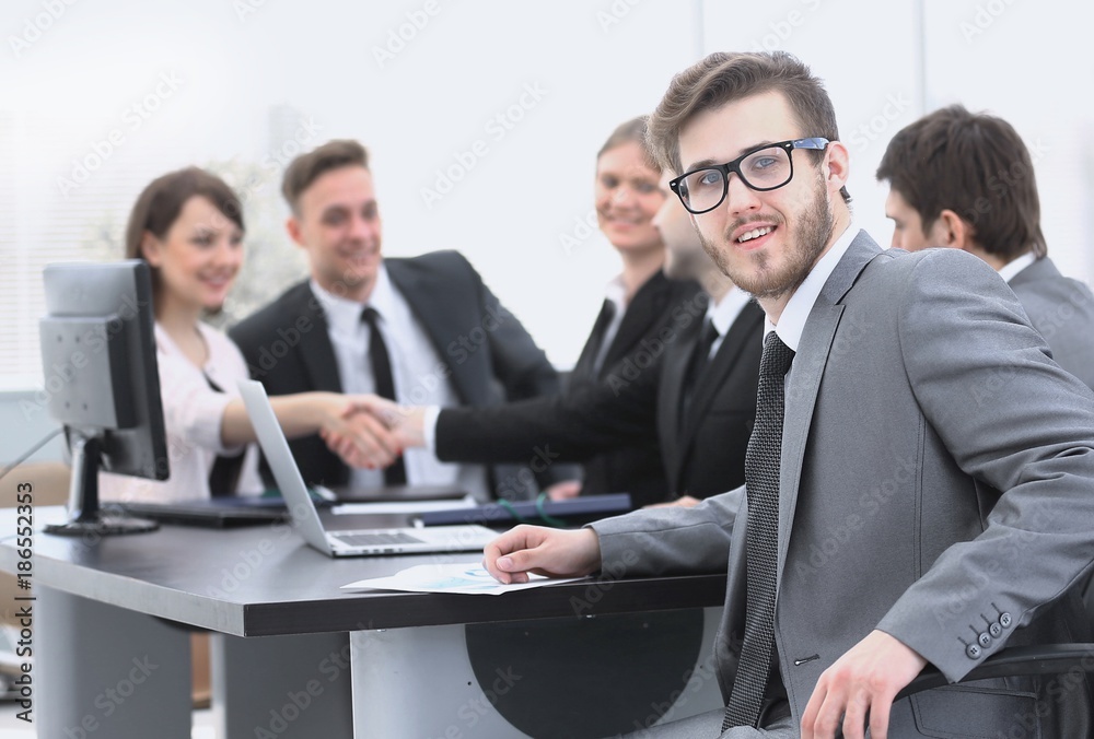 handshake business partners with the Manager in the foreground handshake business partners with the Manager in the foreground