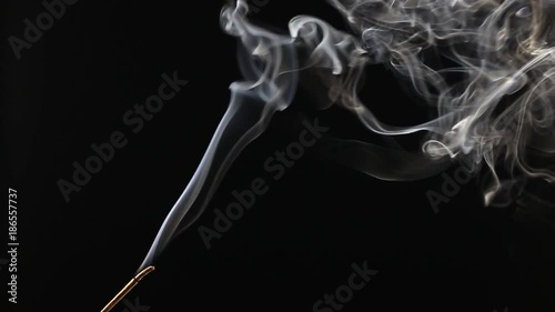 A burning Indian incense with amazing smoke patterns photo