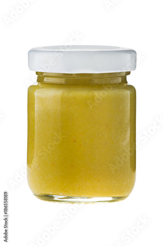 Hot chili mustard in glass on white background