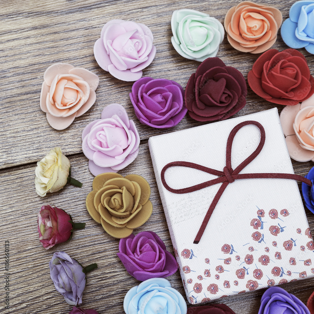 Symbol of Valentine's day. Gift box with group of roses over wooden table. Top view. Symbol of Valentine's day. Gift box with group of roses over wooden table. Top view.