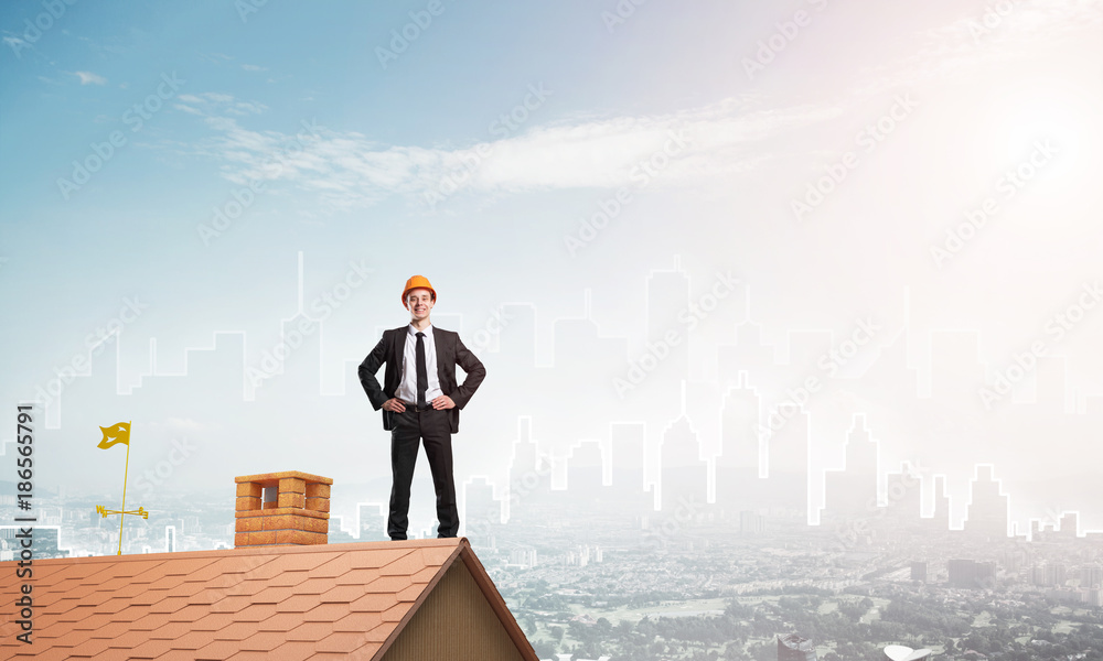 Engineer man standing on roof and looking away. Mixed media Engineer man standing on roof and looking away. Mixed media