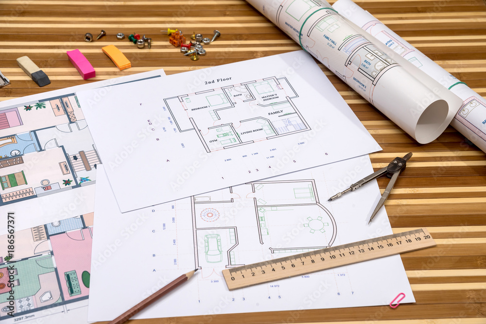 Fototapeta premium plan of apartment rooms and blueprint rolls with work tolls