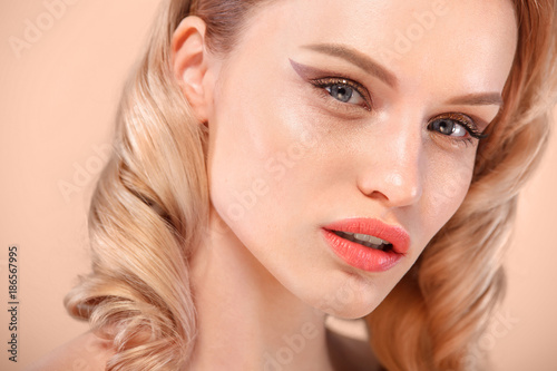Close up shot of charming Caucasian female with blond hair, gently looking at camera. Tender, beautiful, young.