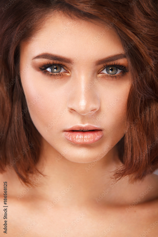Closeup portrait of beautiful young woman with clean and fresh skin. Nude makeup with smoky eyes. Facial treatment . Concept for cosmetology, beauty and spa . Closeup portrait of beautiful young woman with clean and fresh skin. Nude makeup with smoky eyes. Facial treatment . Concept for cosmetology, beauty and spa .
