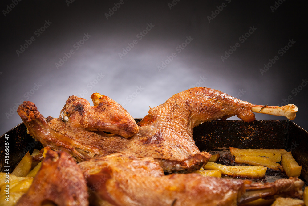 Black Background Porn - Close up view of roast cut chicken with potatoes. Black background. Porn  food Stock Photo | Adobe Stock