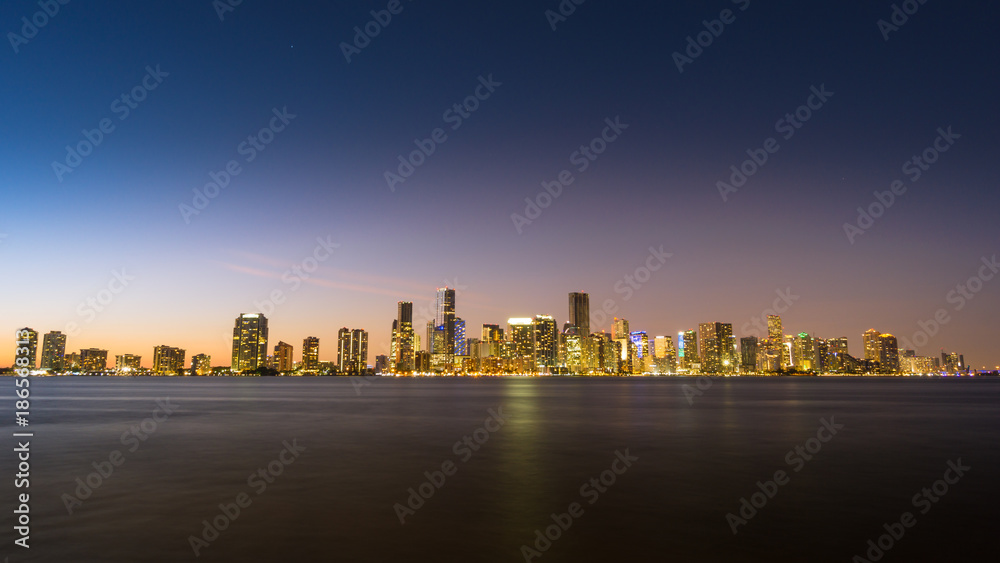 USA, Florida, Dawning atmosphere over the skyline of the city miami from water with light reflections and stars USA, Florida, Dawning atmosphere over the skyline of the city miami from water with light reflections and stars