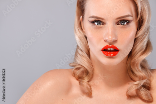Closeup portrait of beautiful young woman with clean and fresh skin. Nude makeup. Facial treatment . Concept for cosmetology, beauty and spa . Gray background.