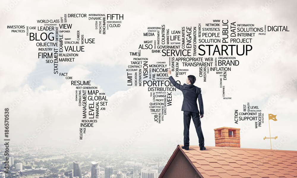 Businessman on brick roof draw world map as concept of globaliza Businessman on brick roof draw world map as concept of globaliza