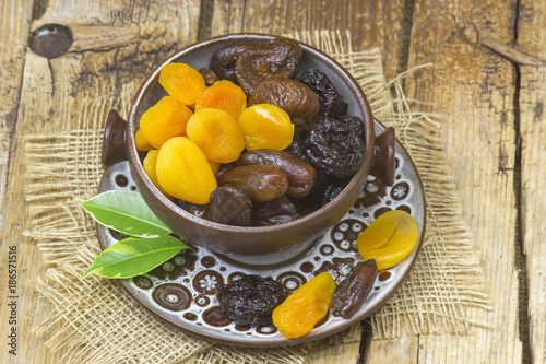 dried fruits in a bowl on wooden background