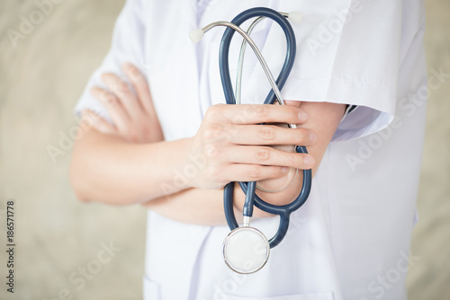 confidential woman doctor with green stethoscope in hand