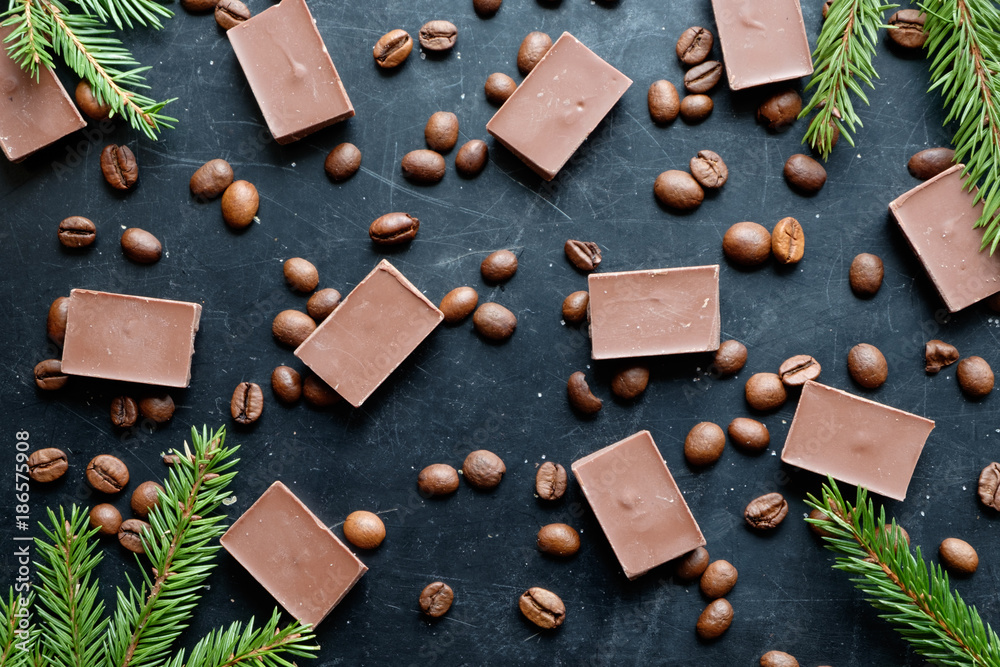 coffee beans with chocolate pieces on black background flat view coffee beans with chocolate pieces on black background flat view