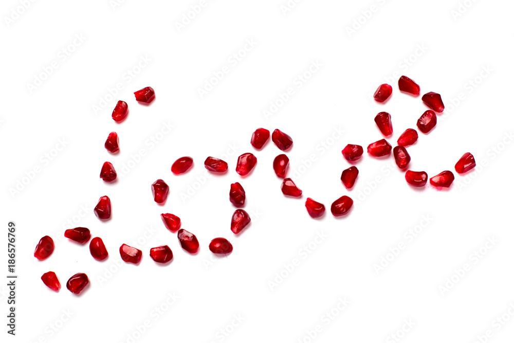 Inscription love of pomegranate grains on white white background.Concept love, valentine's day.Font
