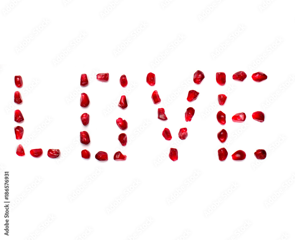 Inscription love of pomegranate grains on white white background.Concept love, valentine's day.Font Inscription love of pomegranate grains on white white background.Concept love, valentine's day.Font