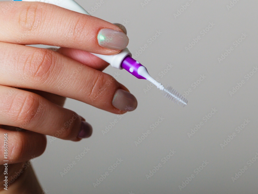 Woman holding toothbrush special for braces Woman holding toothbrush special for braces
