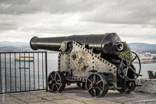 Old vintage cannon protecting sea bay on rock of Gibraltar