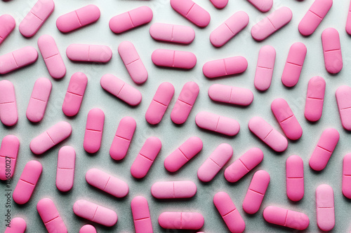 Pink medicine pills on a grey