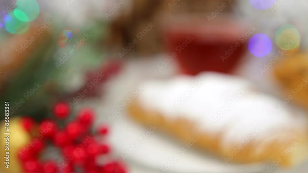 a cup of tea with honey and croissant , a branch of a Christmas tree in the snow, Christmas lights a cup of tea with honey and croissant , a branch of a Christmas tree in the snow, Christmas lights