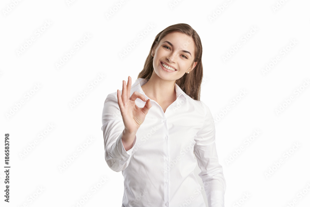 Everything is perfect at the business life. Beautiful young woman gesturing okay sign. Everything is perfect at the business life. Beautiful young woman gesturing okay sign.