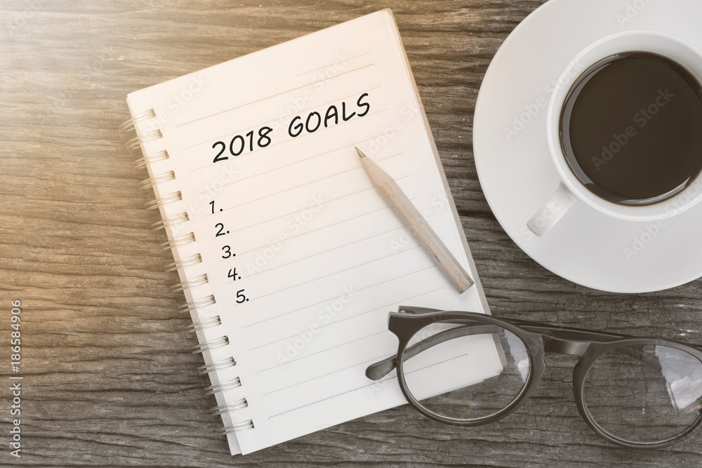 Plakat 2018 Goals concept on notebook with glasses, pencil and coffee cup on wooden table.