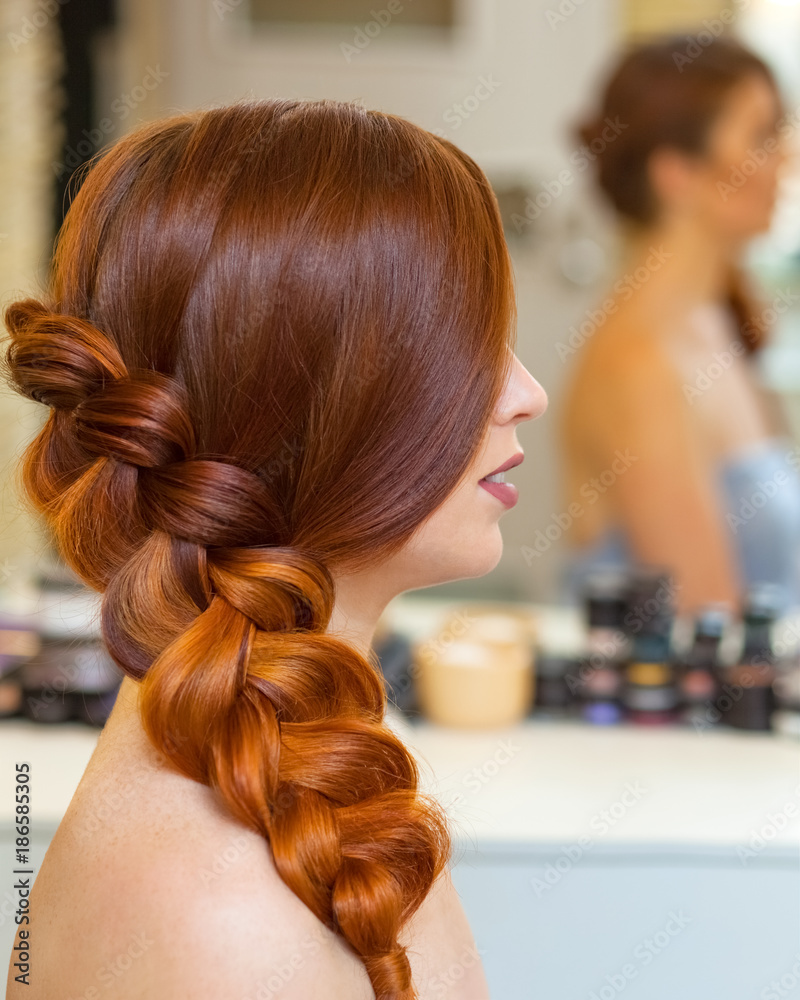 Beautiful girl with long red hair, braided with a French braid, in a beauty  salon. Professional hair care and creating hairstyles. Stock Photo | Adobe  Stock