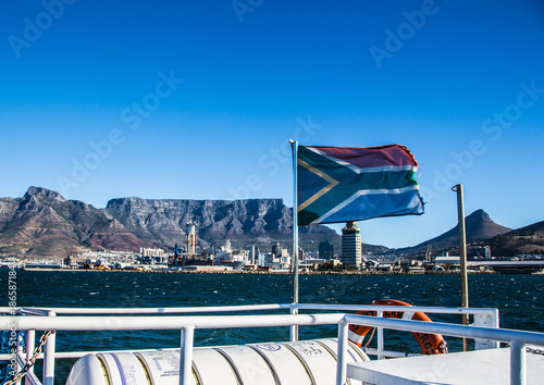 The flags of South Africa is blowing in the Wind in front of the Table Mountain in Cape Town in South Africa