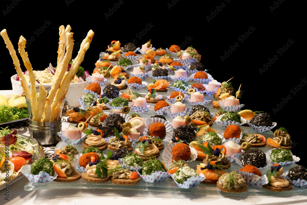 Exquisite snacks arranged on the table. - obrazy, fototapety, plakaty 