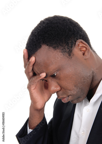 Depressed African man with hand on face