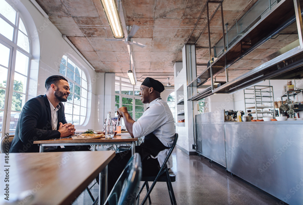 Restaurant manager talking with a professional chef Restaurant manager talking with a professional chef