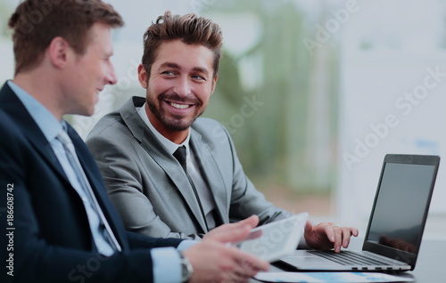 Two handsome businessmen working together on a project in the of