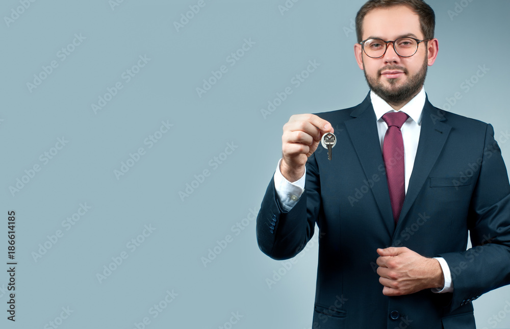 Businessman or real estate agent is holding keys. Businessman or real estate agent is holding keys.