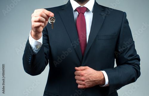 Businessman or real estate agent is holding keys.