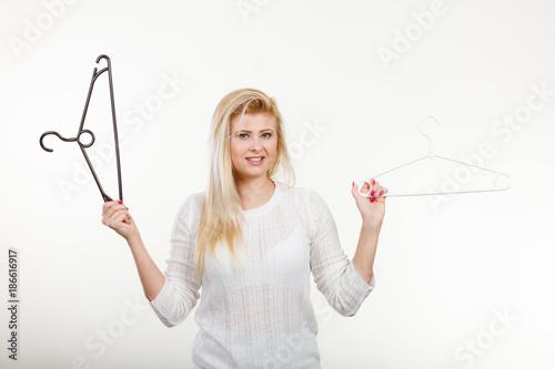 Woman holding clothes hanger photo