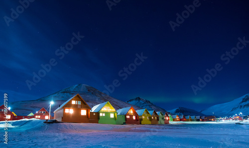 The polar arctic Northern lights aurora borealis sky star in Norway Svalbard in Longyearbyen the moon mountains