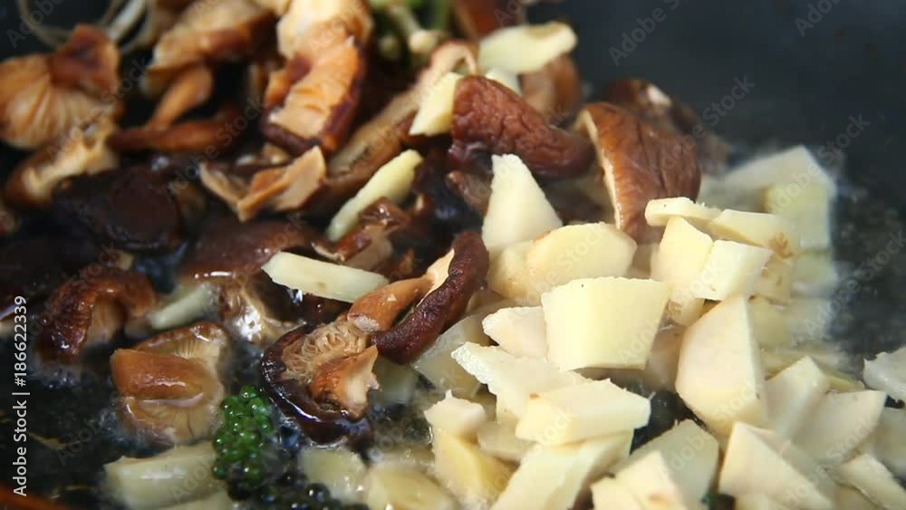 Frying ginger shiitake and celery root in pan Frying ginger shiitake and celery root in pan