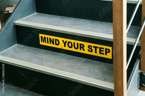 Staircase with mind your step warning sign  