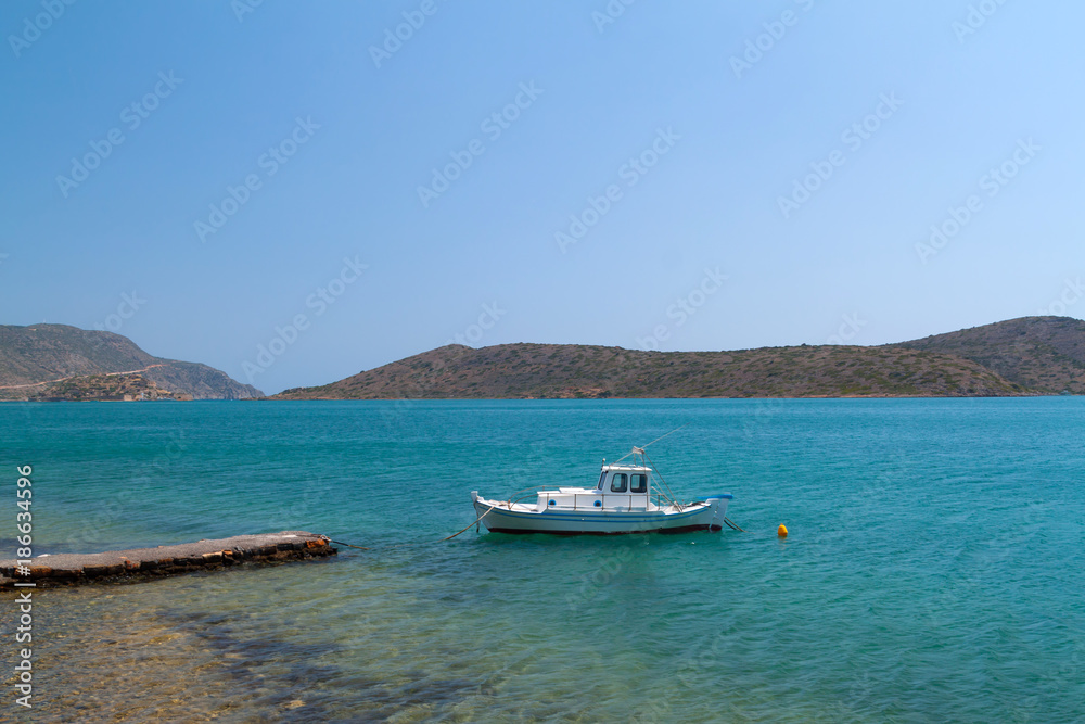 Boat on the blue lagoon of Crete, Greece