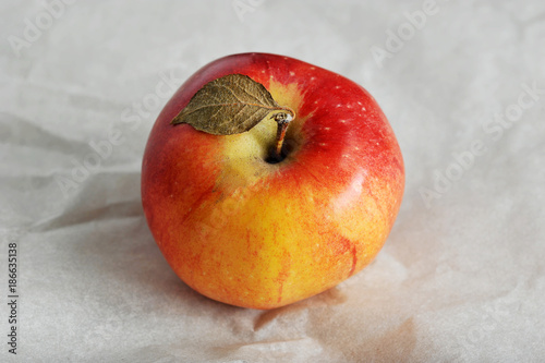 one yellow ripe red Apple with leaf