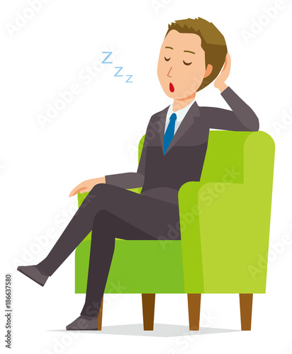A young businessman is falling asleep sitting on the sofa