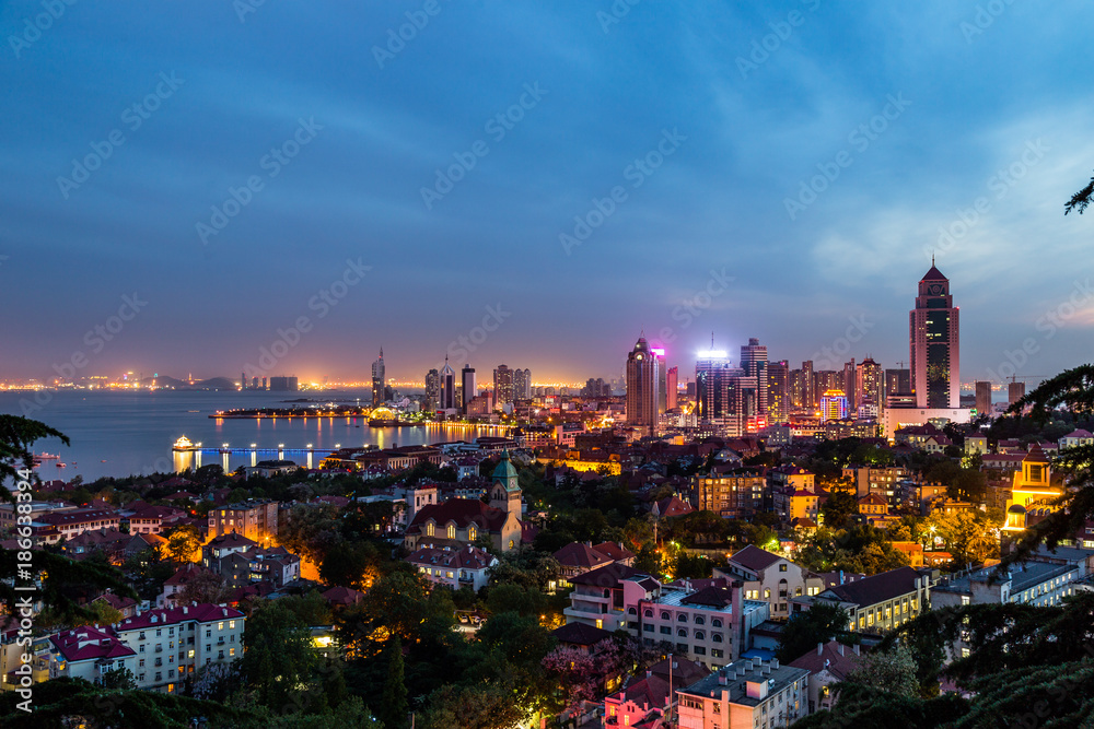 Qingdao Bay and the Lutheran church seen from the hill of Signal Park at evening, Qingdao, China