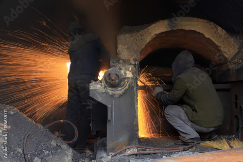 The workshop welder cuts metal      