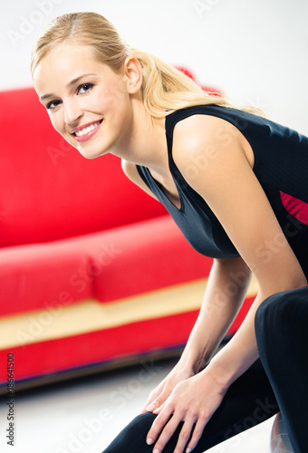 Young woman doing fitness exercise, indoors