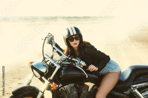 young woman sitting on a motorcycle