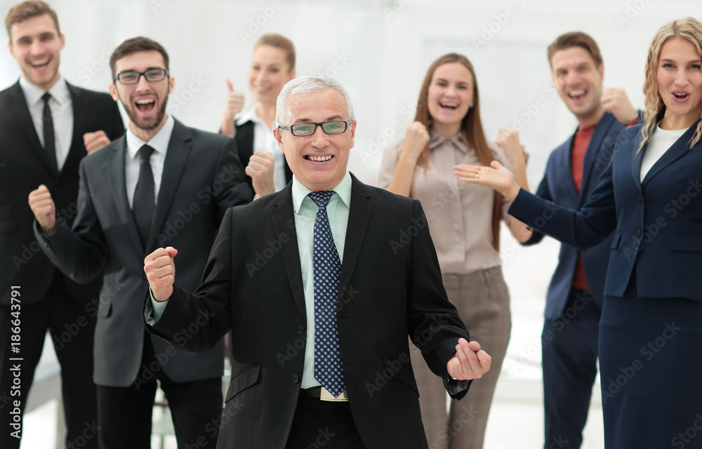 happy senior businessman and triumphant business team happy senior businessman and triumphant business team