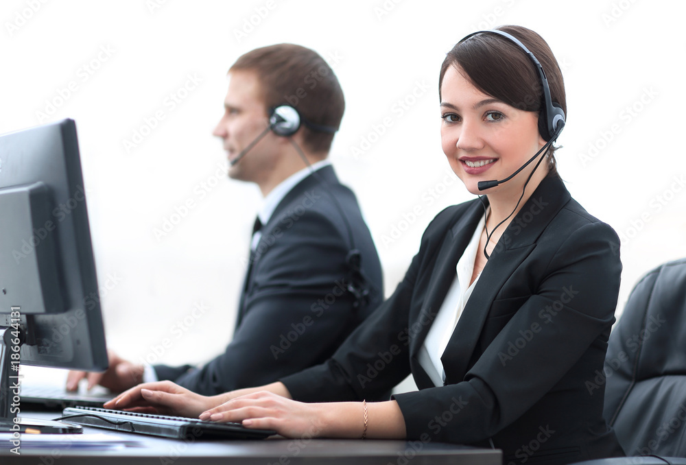 Female Customer Services Agent With Headset Working In A Call Center Female Customer Services Agent With Headset Working In A Call Center