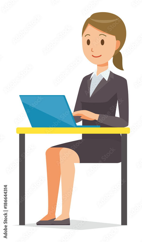 A business woman in a suit is operating a laptop computer A business woman in a suit is operating a laptop computer