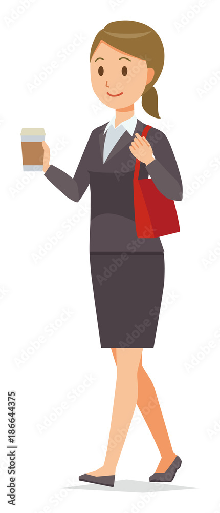 A business woman in a suit is walking with coffee A business woman in a suit is walking with coffee