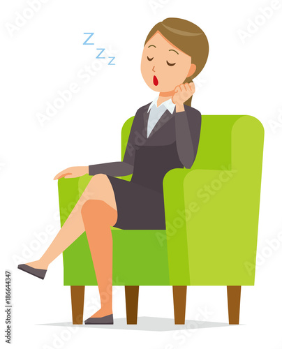 A business woman in a suit is falling asleep sitting on the sofa