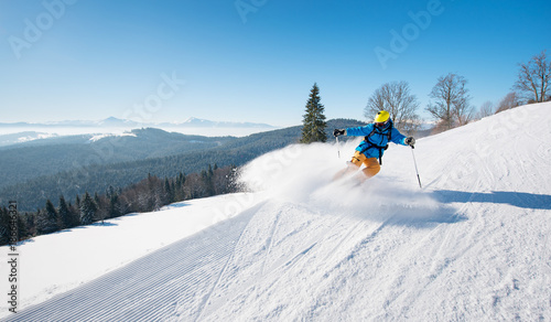 Professional skier riding the slope on a beautiful winter day ski resort recreation travelling tourism vacation extreme adrenaline