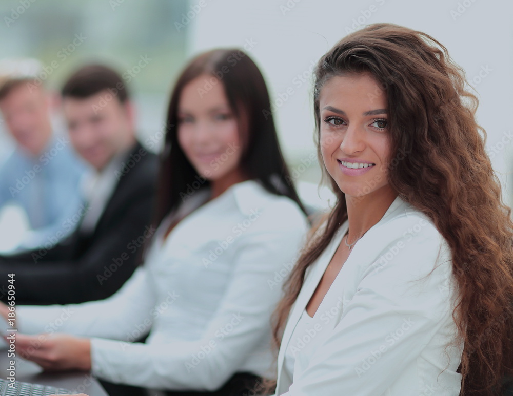 Young businesswoman working in an office using computer with co Young businesswoman working in an office using computer with co