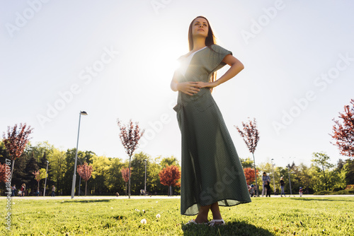 Full leight portrait of woman in dress in park photo